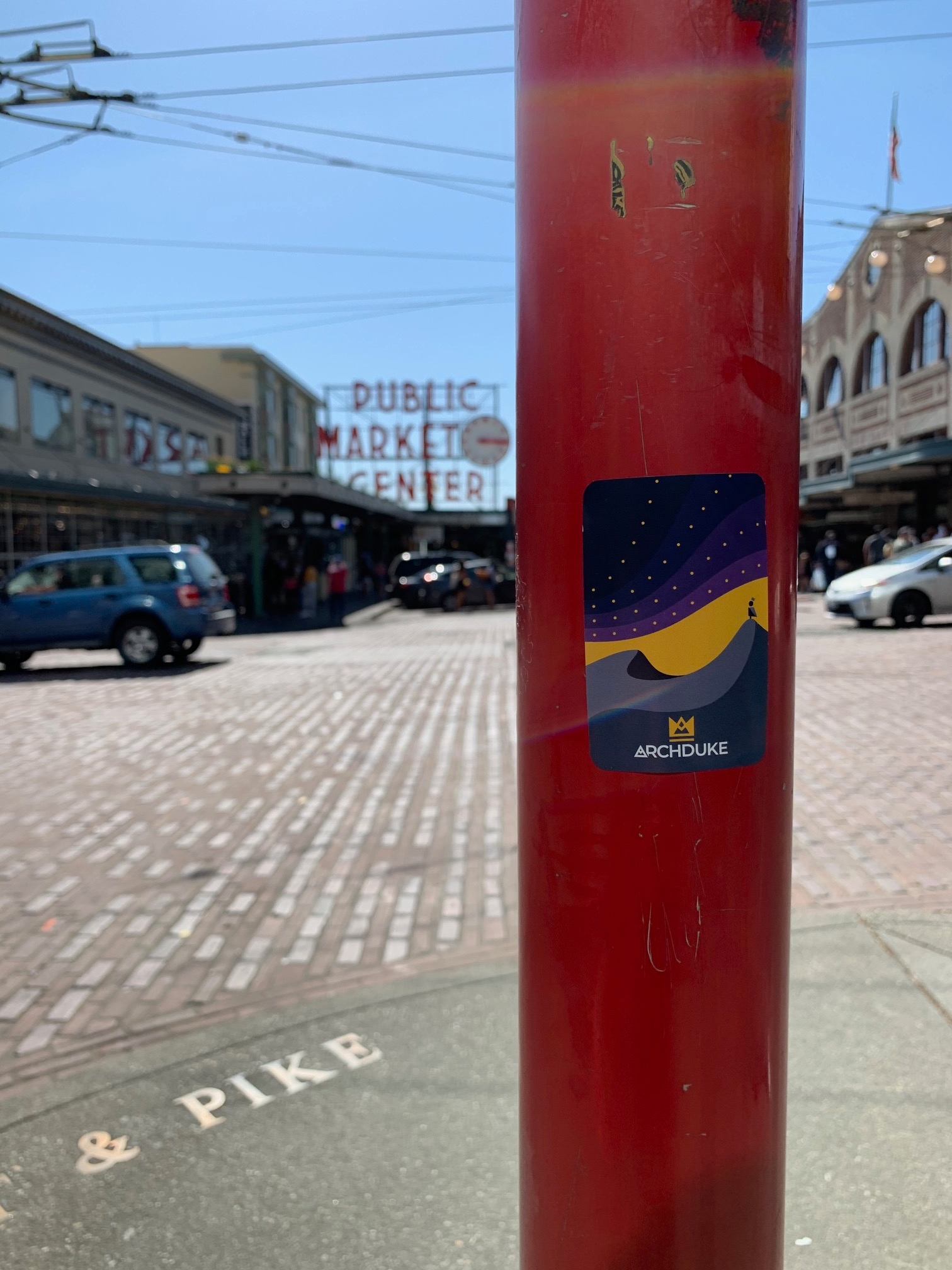 Archduke sticker affixed to a wooden pole outdoors
